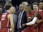 Washington State players and coaches rush to greet Malachi Flynn (22) after Flynn scored against Washington in the final moments of the second second half of an NCAA college basketball game Sunday, Jan. 1, 2017, in Seattle. Washington State won 79-74.