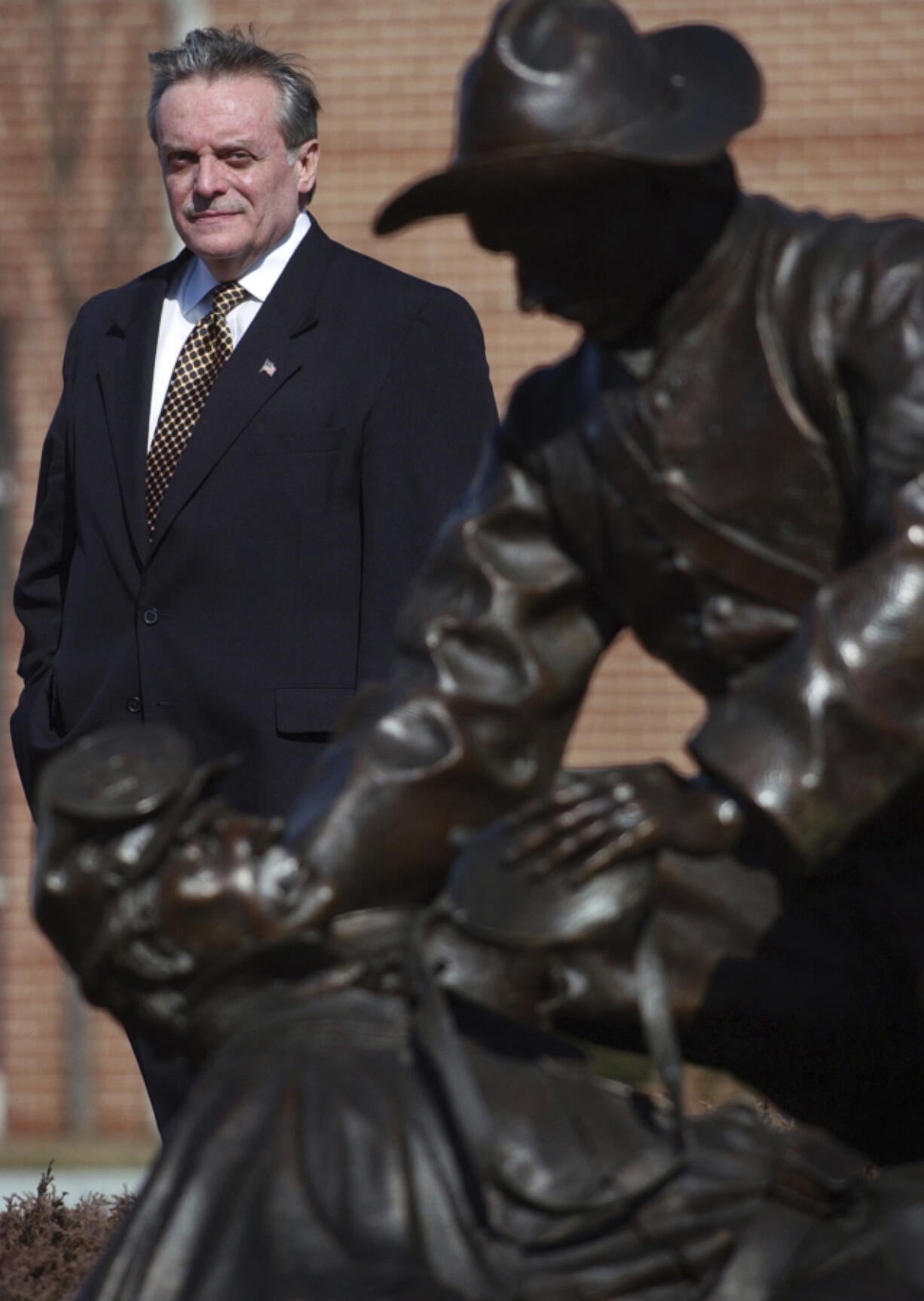 In this March 15, 2004 file photo, Harrisburg, Pa., Mayor Stephen Reed stands behind the bronze sculpture Moment of Mercy by Terry Jones at the National Civil War Museum in Harrisburg, Pa. Jury selection is set to begin Monday, Jan. 23, 2017, in the criminal case against Reed, charged with receiving stolen property after spending millions in public funds to buy artifacts for a Wild West museum that was never built. His lawyer says Reed didn&#039;t steal anything and was in lawful possession of the items.