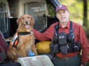 Robert Calkins and Ruger, his current search dog and pet. Calkins writes about Sierra, his dog of years ago, in search and rescue tales.