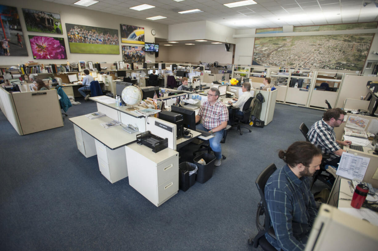 Staff members of The Columbian work in the newsroom Friday afternoon, June 10, 2016.