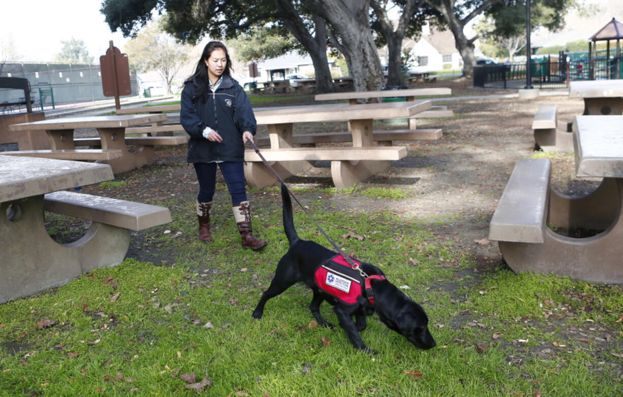 Patsy works with her service dog, Andromeda.