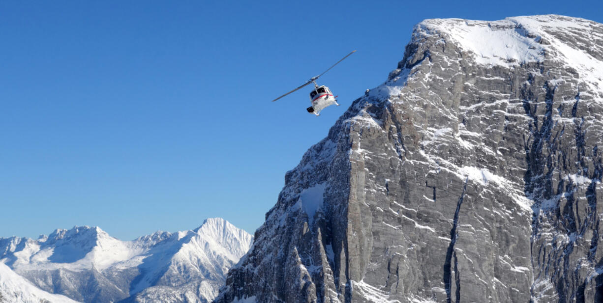 A helicopter operated by pioneer CMH Heli-Skiing hugs a powdery peak in British Columbia.MUST CREDIT: Photo for The Washington Post by Rachel Walker (Photos by Rachel Walker for The Washington Post)