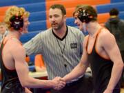 Washougal junior Tanner Lees, left, shakes teammate Nick Wolfe's hand after defeating him to win the 145-pound weight class in the 2A regional finals at Ridgefield High School on Saturday, February 11, 2017.