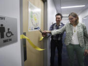 Abe Noe-Hays, director of research at the Vermont-based Rich Earth Institute, left, and Nancy Love, professor of civil and environmental engineering at the University of Michigan, cut the ribbon to a men&#039;s bathroom with a special toilet.