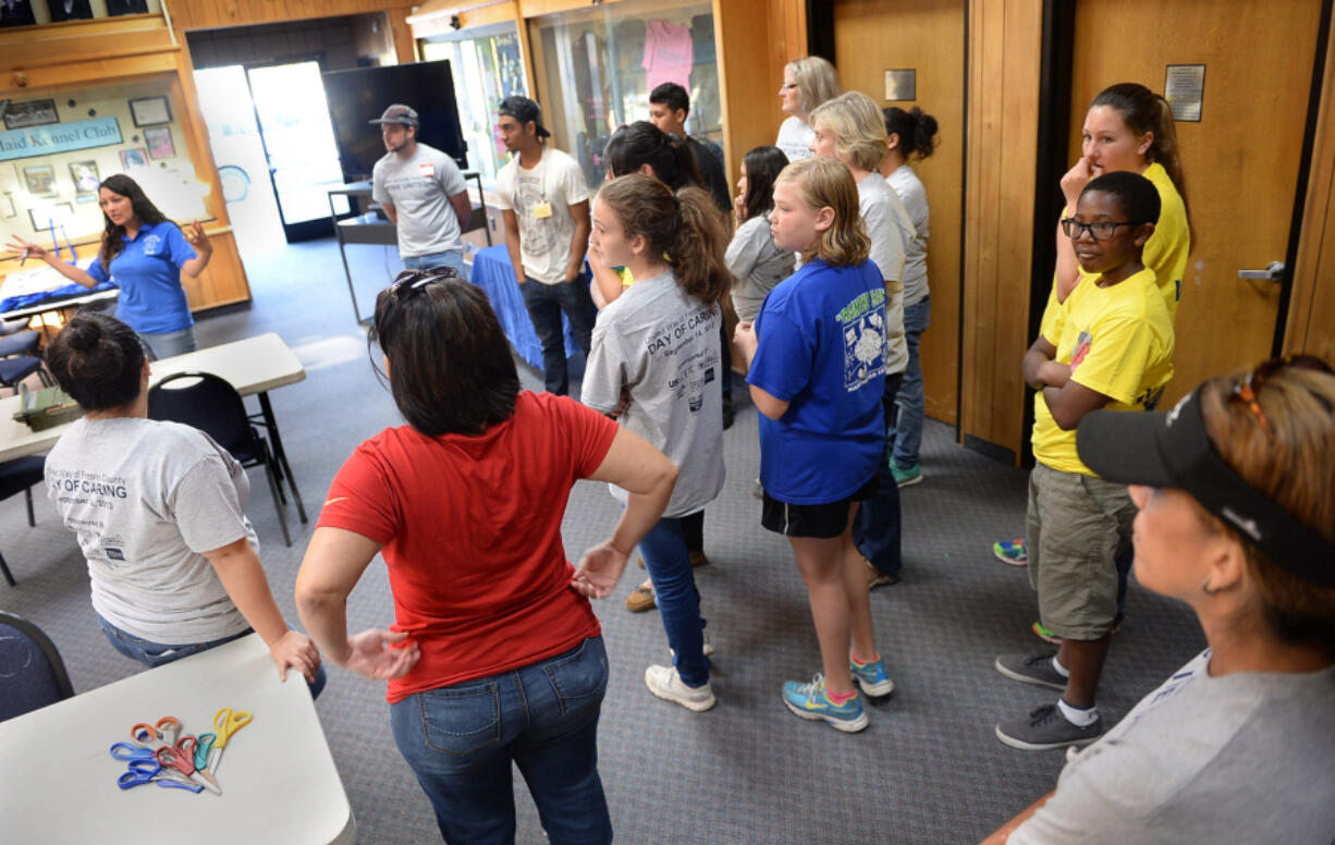 Thalia Arenas, left, a humane educator, gives volunteers an orientation at Central California SPCA.