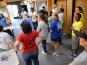 Thalia Arenas, left, a humane educator, gives volunteers an orientation at Central California SPCA.