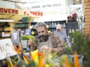 Bob Mangia arranges flowers at the North Market, which has more than two dozen merchants.