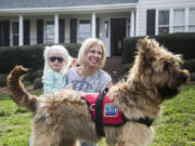 Tara Deane and her 4-year-old daughter Eliana, who has albinism and autism and is partially sighted, work with Eliana&#039;s service-dog-in-training, Butters, this month.