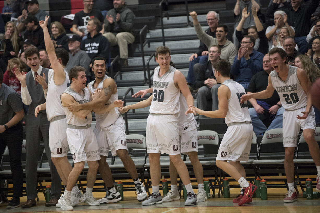 Union boys basketball players celebrate a basket in the their bi-district tournament win over Olympia last month, helping send the Titans back to the Tacoma Dome.