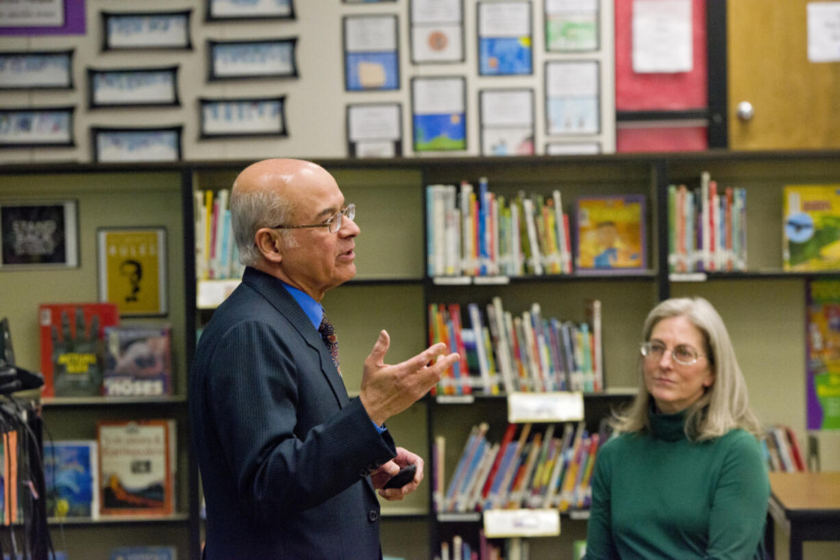 Fircrest Neighborhood Association Co-Chair Margaret Milem, right, listens as Khalid Khan of the Islamic Society of Southwest Washington gives a &quot;What is Islam?&quot; presentation to neighborhood association members at their Feb. 7 meeting. Some residents in the neighborhood were upset association leaders opted to go through with a meeting topic focusing on religion.