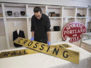 Vancouver resident Todd Clark helps arrange historical signs for an upcoming exhibit at the Clark County Historical Museum, which reopens Saturday.