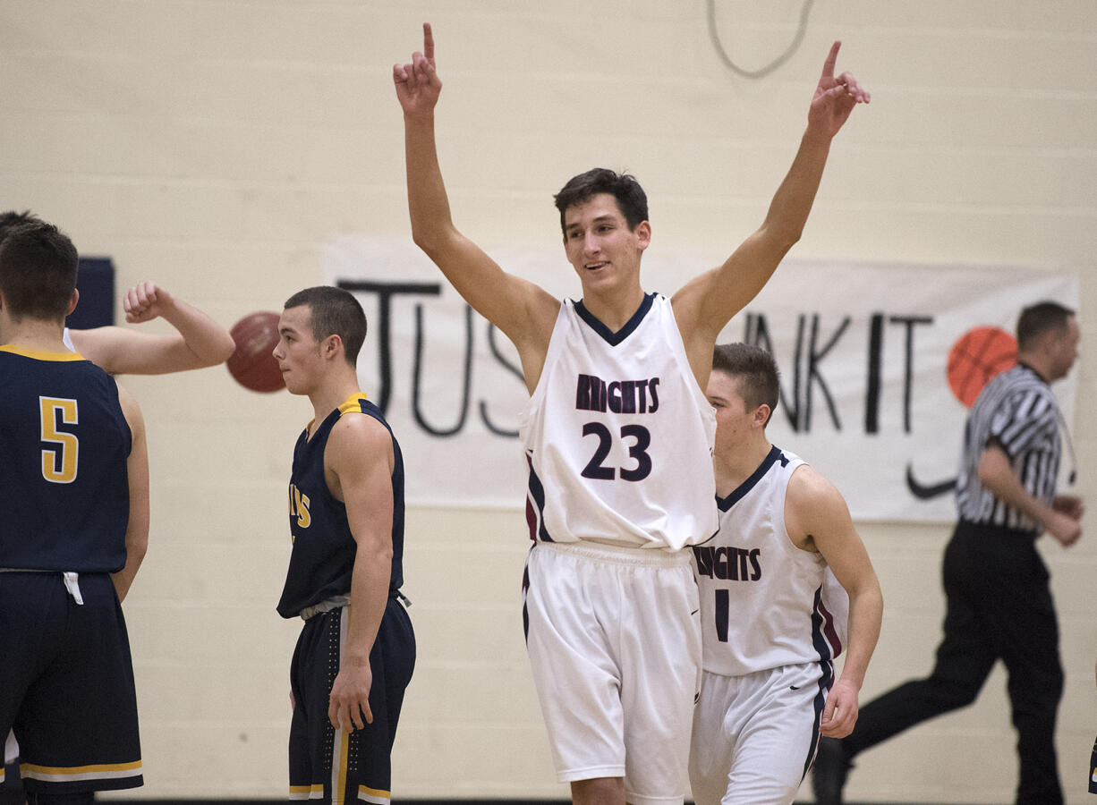 Matt Garrison of King's Way (23) celebrates the win over Forks with teammates after the game at King's Way High School on Monday night, Feb. 13, 2017.