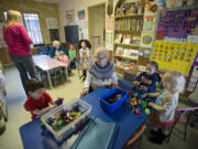 Children&#039;s Day Care Center director Anna Wingate, center, takes part in playtime Jan. 26 at the Gingerbread House. Wingate, 81, retired Jan. 27 after 50 years on the job.