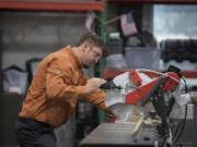 Mathias Forsman, a TigerStop representative, demonstrates one of its precision saw products. The company expects to ride the rise of automation to an 18 percent growth in revenues this year.