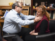 Dr. Dino Ramzi checks patient Wendi Deans&#039; sore neck during an appointment Feb. 10 at his clinic, Patient Direct Care, in Battle Ground. The clinic uses a model called direct primary care, in which people pay a monthly fee for access to primary care services.