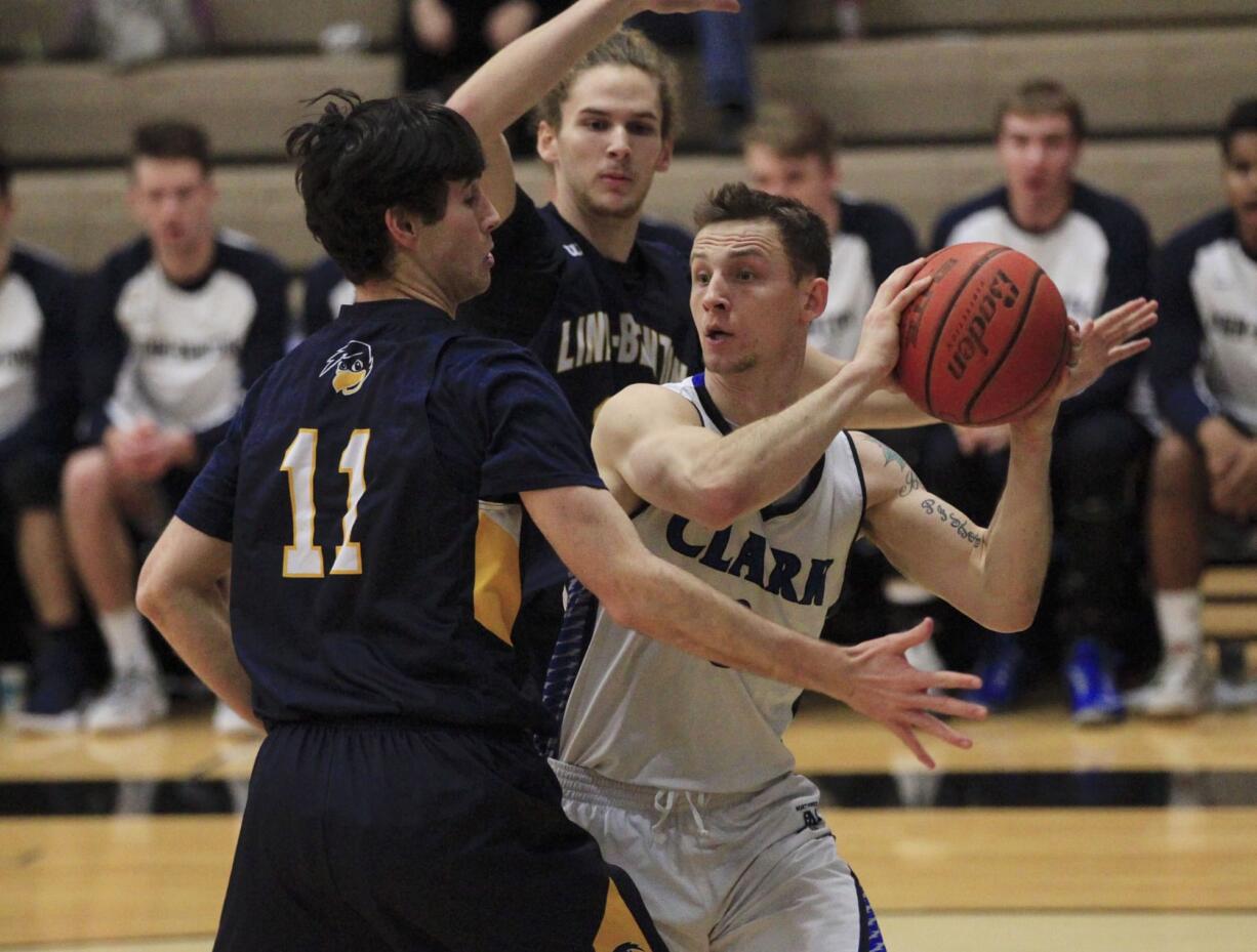 Clark College basketball's Jordan Berni, right.