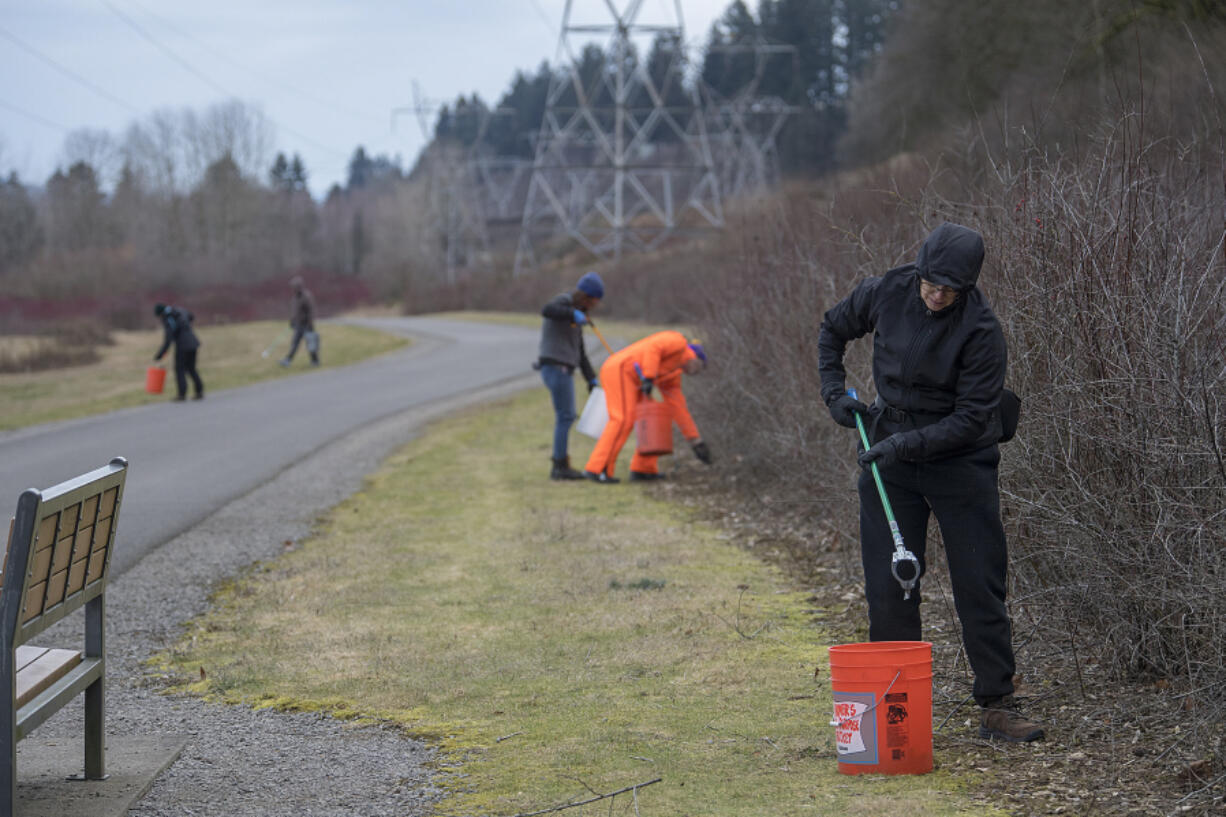 Holly Williams of the city of Vancouver Parks and Recreation Advisory Commission, right, joins Vancouver Volkssport Club members as they clear garbage.