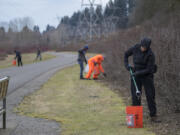 Holly Williams of the city of Vancouver Parks and Recreation Advisory Commission, right, joins Vancouver Volkssport Club members as they clear garbage.