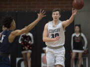 Union's Cameron Cranston (30) passes against Olympia's Casson Rouse (5) in the first quarter at Union High School on Thursday night, Feb. 9, 2017.