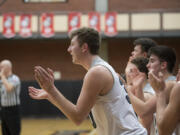 Union's Cameron Cranston, center, joins fellow players as they cheer on teammates from the bench against Olympia at Union High School on Thursday night, Feb. 9, 2017.