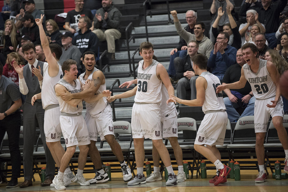 Players and fans celebrate a basket against Olympia late in the fourth quarter at Union High School on Thursday night, Feb. 9, 2017.