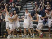 Players and fans celebrate a basket against Olympia late in the fourth quarter at Union High School on Thursday night, Feb. 9, 2017.