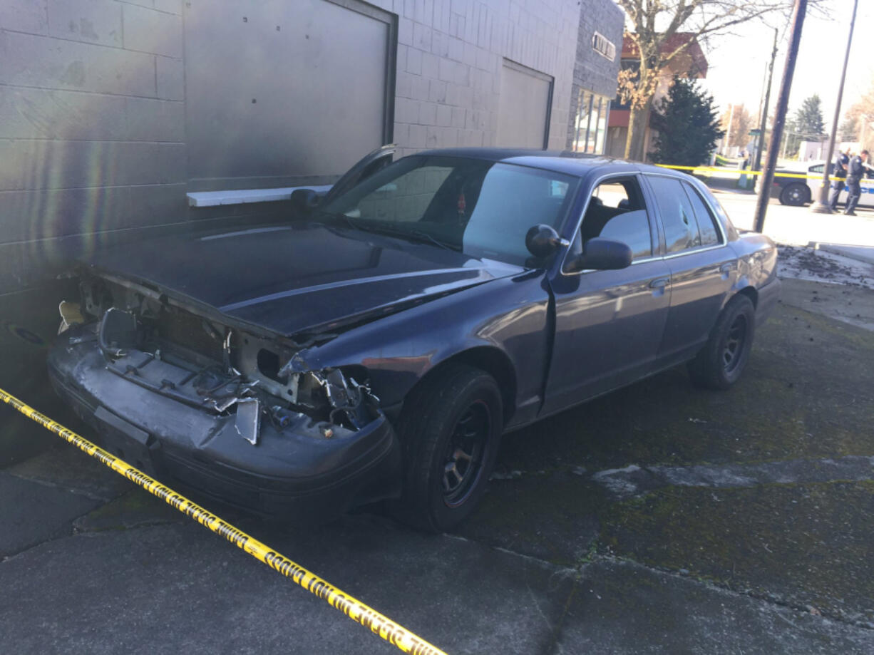 Photos by Emily Gillespie/The Columbian
Police said this dark-colored sedan was the vehicle driven by a suspect who fled from officers Saturday morning. An officer fired at the vehicle before the sedan crashed into another vehicle and a building several blocks away. The suspect, who was injured, fled on foot but was apprehended at 15th and C Streets.