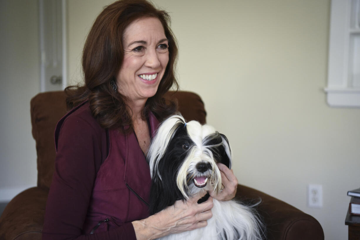 Lee Whittier pets her show dog, 18-month-old Tibetan terrier Oliver, at her home in Vancouver on Feb. 3. Whittier will judge at the 141st annual Westminster Kennel Club Dog Show in New York.