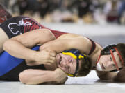 Camas' Dylan Ingram, right, puts the squeeze on Mariner's Cayden Herbert during their 220 lb. 4A State Wrestling quarterfinal match Friday, Feb. 17, 2017, in Tacoma, Wash. Ingram won 7-1 to advance.