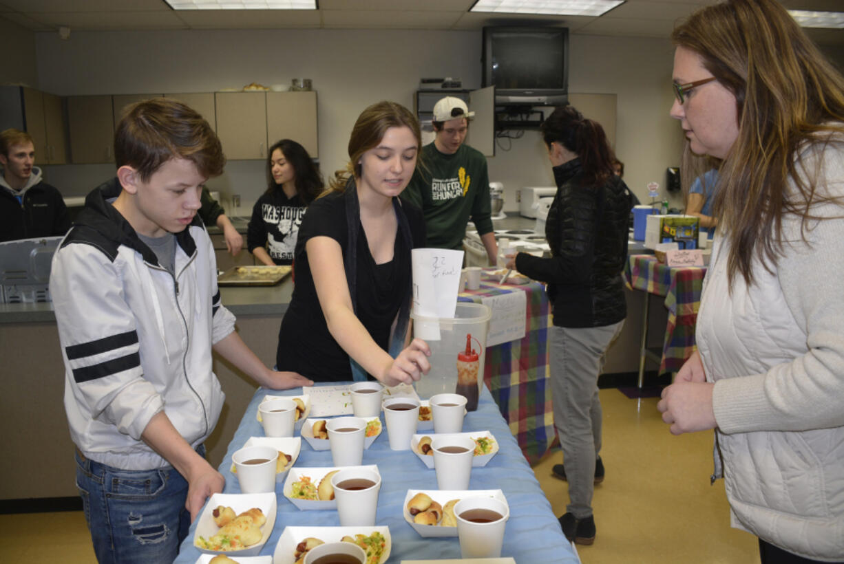 Washougal: Washougal High School culinary students Braiden Williams, left, and Jolene Porter serve Melissa Tauialo during the school&#039;s Food Truck Face Off.