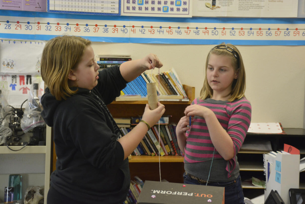 Washougal: Hathaway Elementary School fifth-graders, including Grace West, left, and Avis Berg, were asked to design and construct Valentine&#039;s Day boxes using the concepts of simple machines: pulleys, wedges, screws, levers, wheels and ramps.