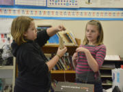 Washougal: Hathaway Elementary School fifth-graders, including Grace West, left, and Avis Berg, were asked to design and construct Valentine&#039;s Day boxes using the concepts of simple machines: pulleys, wedges, screws, levers, wheels and ramps.