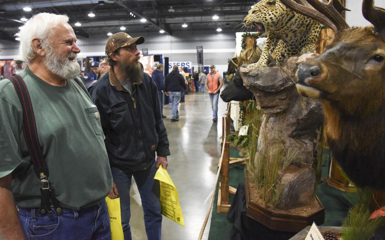 Hank Seth, left and Bran Tharp look at the Natural Instincts Taxidermy exhibit at the Pacific Northwest Sportsmen’s Show at the Portland Expo Center, Wednesday February 8, 2017.