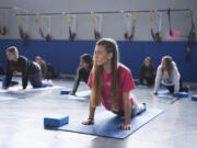 Running Start student Makayla Draper follows along in a yoga class at Clark College.