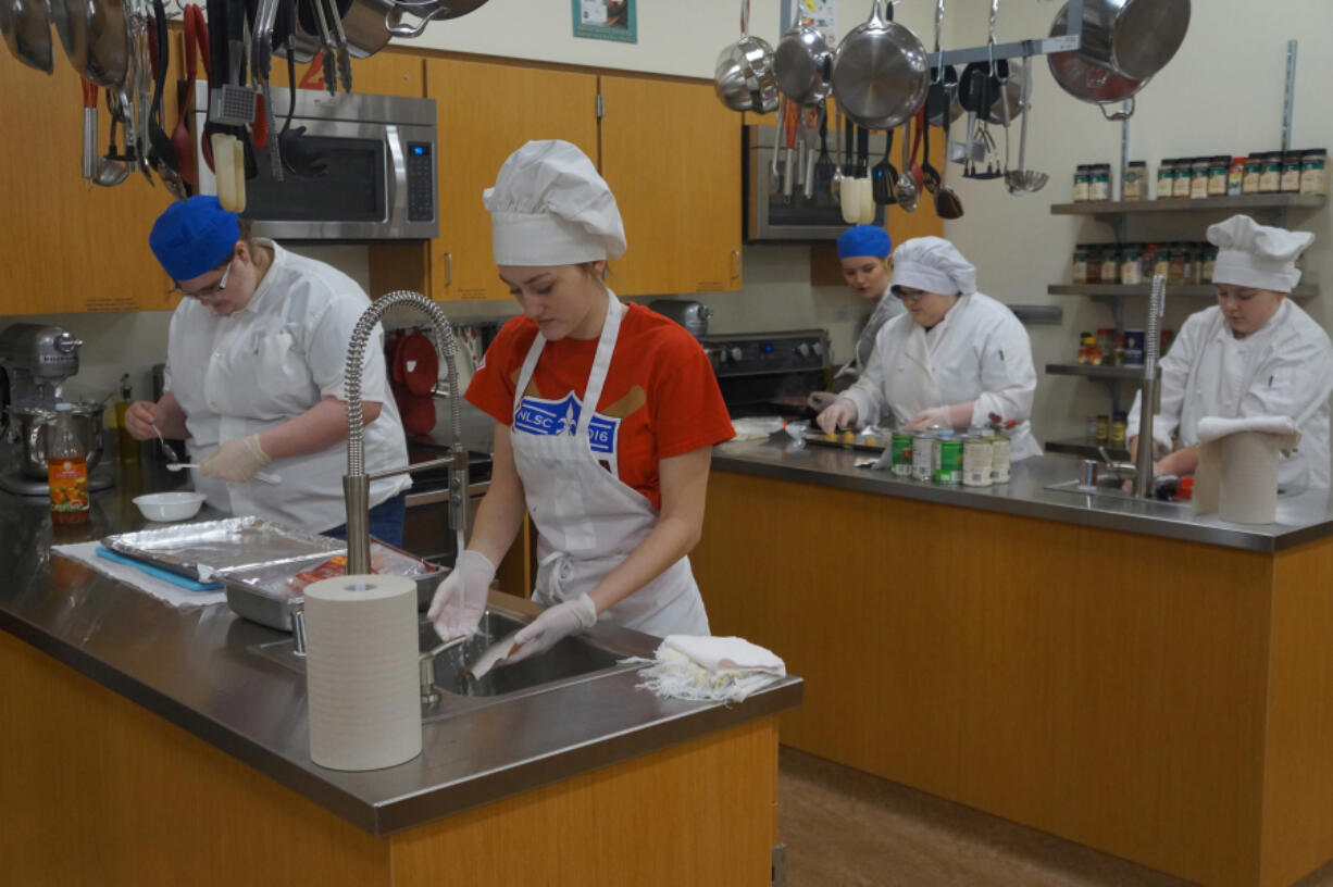 Woodland: Woodland High School SkillsUSA team members Deja Peterson, from left, Carinda Washburn, Brooke Schimmel, Daphne Mendoza and Katelynn-Paulson working on a culinary competition.