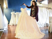 The owner of Sincerely the Bride, Lisa Bagley, looks over a wedding dress at her Vancouver store, Friday February 17, 2017.