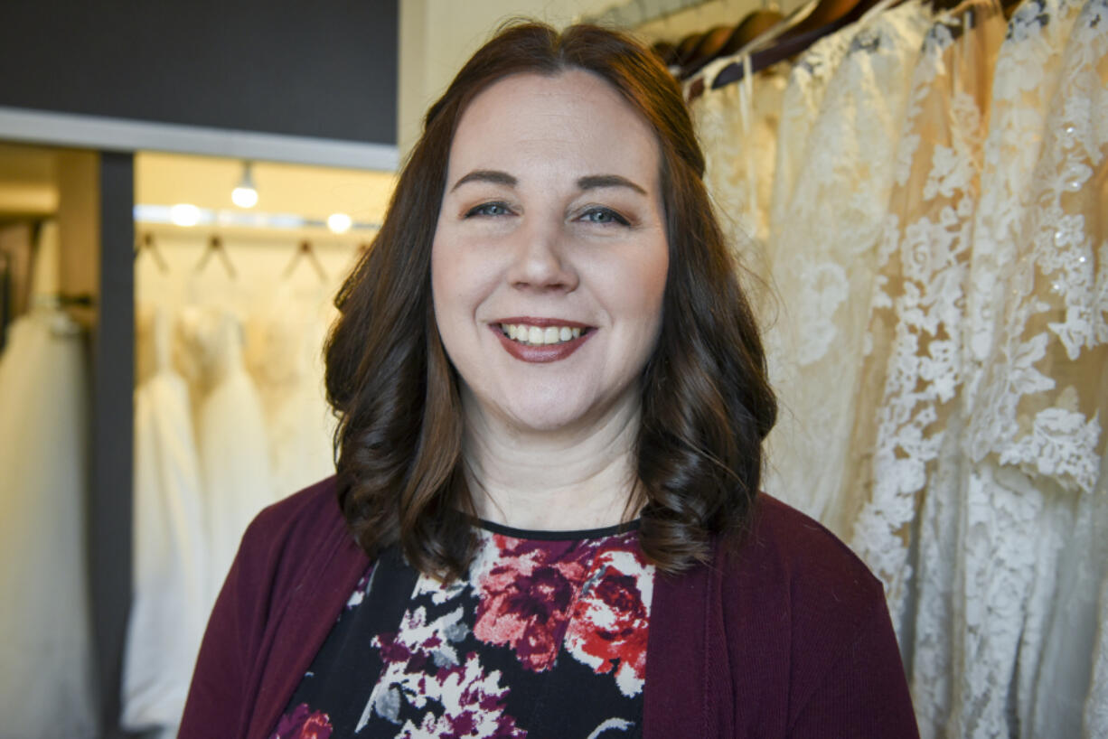 Lisa Bagley, owner of Sincerely the Bride, stands near a display of dresses at her Vancouver store on Friday.