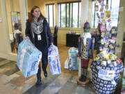 Melanie Green, the administrator of the Family and Community Resource Centers for Evergreen Public Schools, carries toilet paper donated in December to her car from The Reserve at Columbia Tech Center, an apartment complex in east Vancouver. The Family and Community Resource Center received toiletry donations from various Vancouver apartment complexes with the help of ZipEco Recycling &amp; Waste and Investment Development Management in Vancouver.