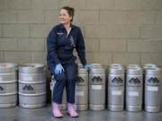 Teri Fahrendorf, malt innovation center manager for Great Western Malting Co., rests on kegs at the company&#039;s in-house brewery. Fahrendorf started brewing in the 1980s and later founded The Pink Boots Society, an organization for women in the beer industry.