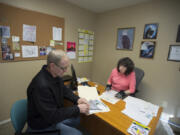 Rob Pengra, left, checks into VA benefits for his mother, the widow of a Navy veteran, in a session with veterans service officer Pamela Davis at the Clark County Veterans Assistance Center on Jan. 27.