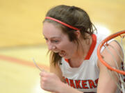 Camas senior Teague Schroeder smiles after cutting a piece of the net after routing Skyview 42-24 to win the 4A Greater St. Helens League title.