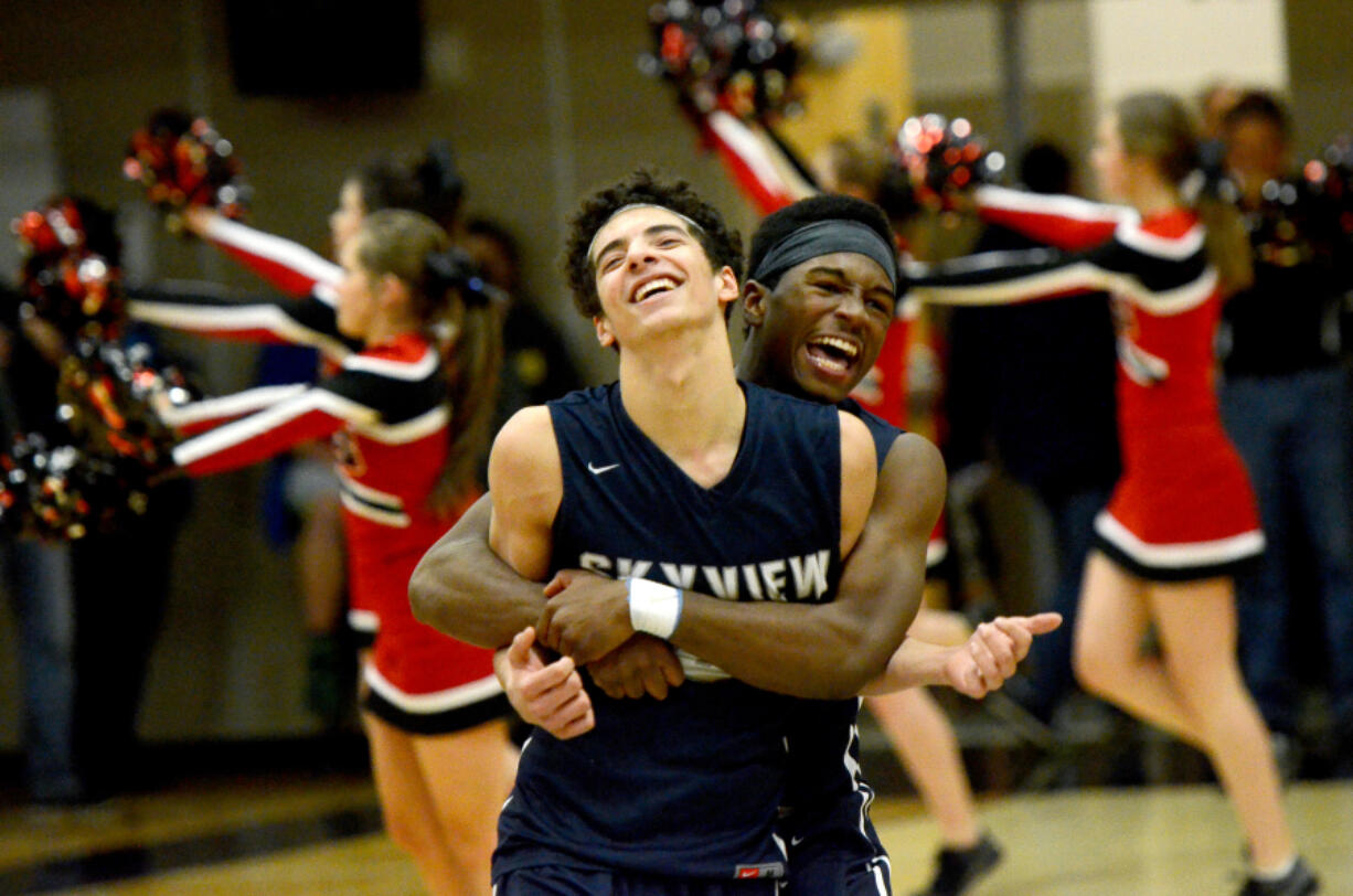 Skyview senior Levi Nickelson hugs teammate Alex Schumacher after Skyview beat Camas 45-44 at Camas High School on Wednesday, February 1, 2017. Schumacher won the game with a late three-pointer.