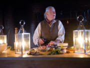 Bob Prinz looks up while slicing a piece of chicken in the kitchen at the Fort Vancouver National Historic Site on Tuesday, January 10. Prinz has been volunteering at Fort Vancouver for nearly 3 years as a re-enactor, demonstrating the techniques and ingredients that would have been used at the original fort in the 1800s.