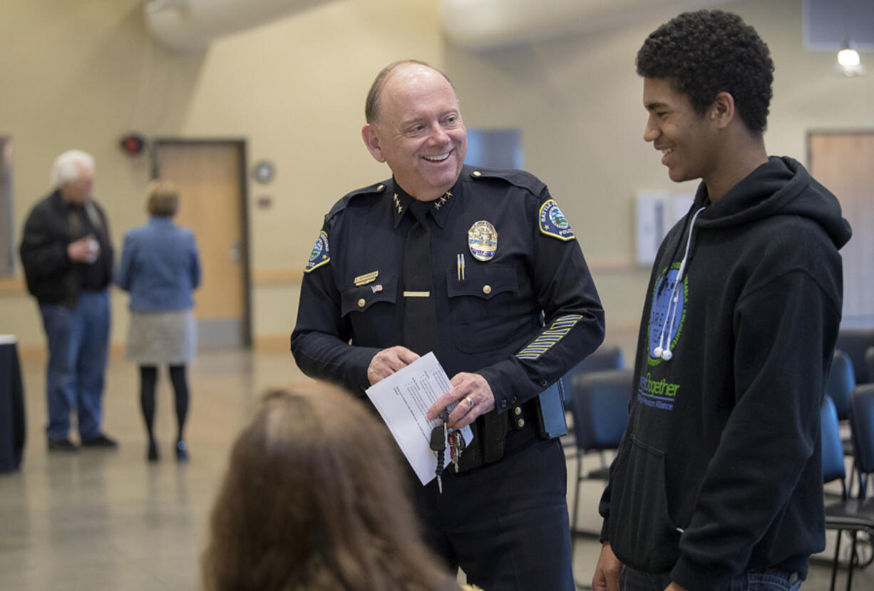 Battle Ground Police Chief Bob Richardson, center, chats with Battle Ground resident Jason Johnson II, 15, Wednesday evening at the Battle Ground Community Center.