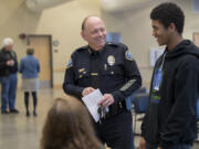 Battle Ground Police Chief Bob Richardson, center, chats with Battle Ground resident Jason Johnson II, 15, Wednesday evening at the Battle Ground Community Center.