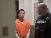 Mitchell Heng, who's accused in the Sifton Market homicide and arson last month, is escorted Wednesday morning, Feb. 1 to Clark County Superior Court to be arraigned on charges of first-degree murder, first-degree arson and first-degree robbery.