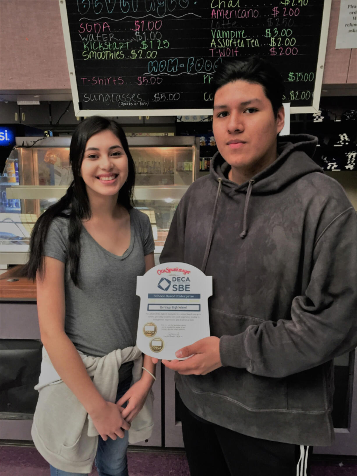 Orchards: Heritage High School students Amy Rodriquez and Luis Reyes worked on getting Heritage&#039;s school-based enterprise certified and will be recognized at the DECA International Career Development Conference in Anaheim, Calif.