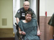 Kenneth Jay Moore, who was arrested after a two-hour standoff Friday at a Vancouver home, is wheeled into Clark County Superior Court on Feb. 21, 2017, on suspicion of murder and assault after his mother's body was found inside the residence.