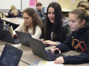 Seventh-graders Katerina Yarosh, left, Rachel Knight, and Emma Jensen work on their new Chromebooks during study hall at Pleasant Valley Middle School on Thursday.