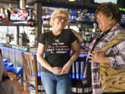 Nancy Koon, right, consoles her sister, Best Friends Dog Grooming owner Sue Picchioni, during a fundraiser Sunday morning at Hooligan&#039;s Sports Bar &amp; Grill in Vancouver. Best Friends lost its shop in the Sifton Market fire in January.